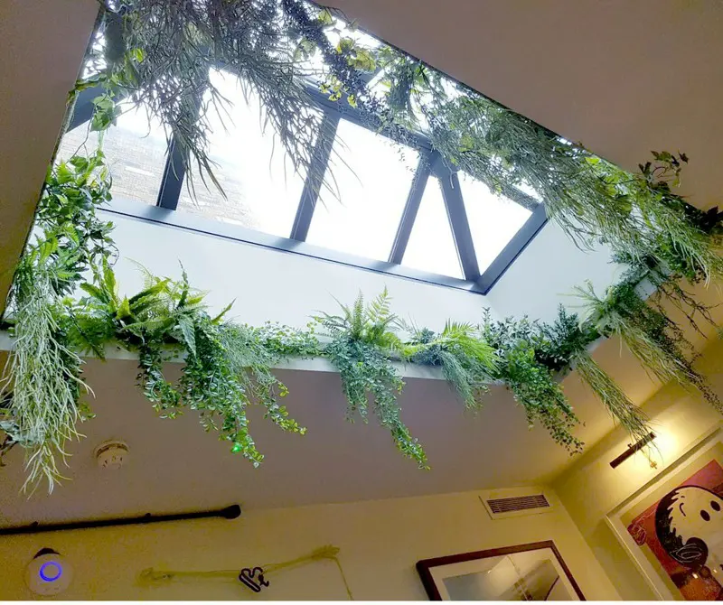 Artificial mixed foliage surrounding roof lantern
