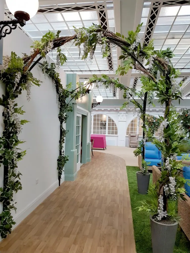 Artificial vines foliated with wisteria applied to bespoke metal pergola