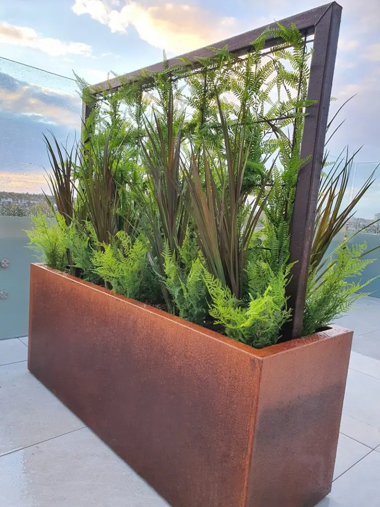 Corten steel trough with artificial planting exterior