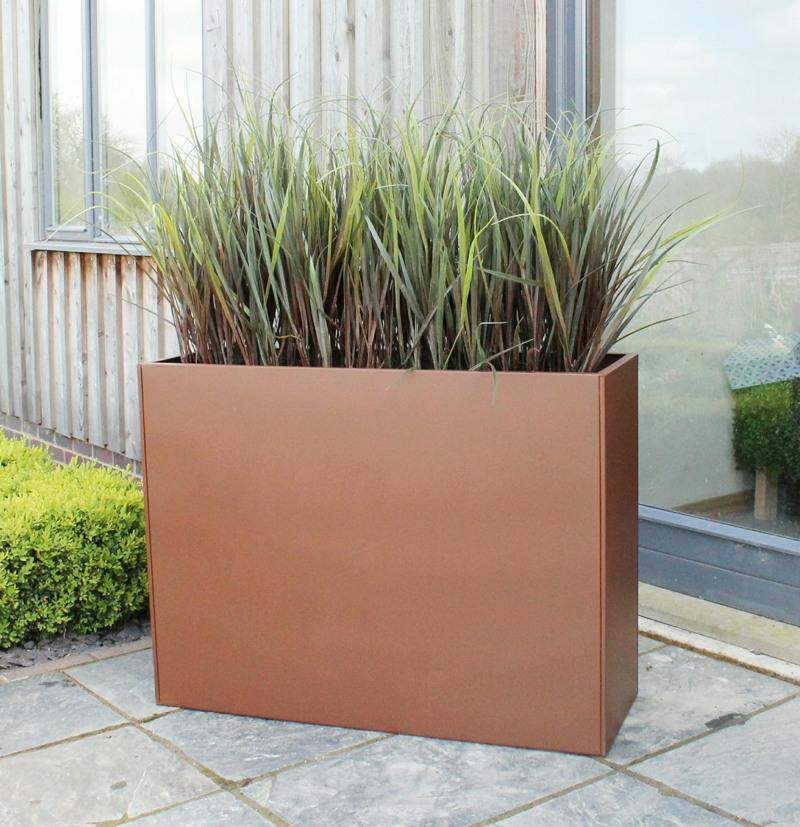 Exterior artificial Burgundy Grass in old iron powder coated tall trough