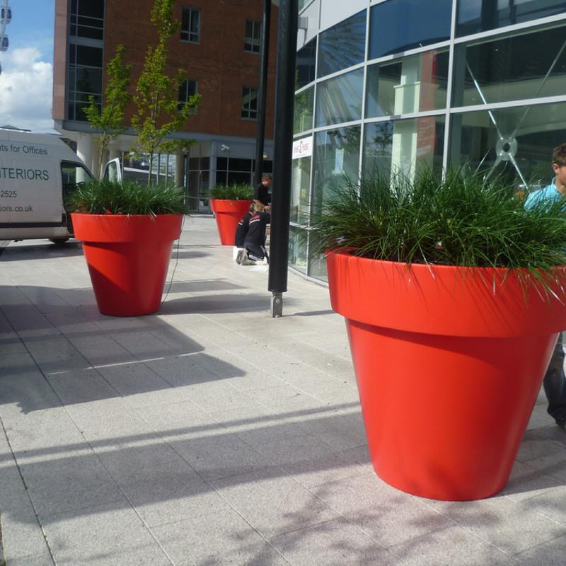Giant red VAS planter with exterior grade artificial Monkey grass